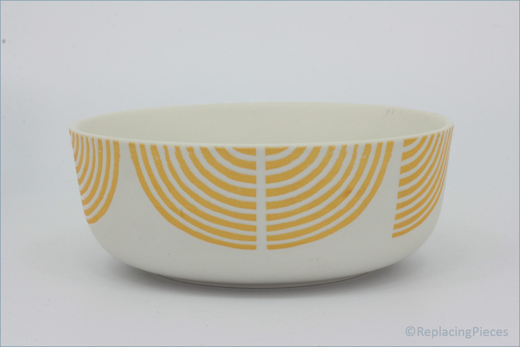 Habitat - Block Print - Cereal Bowl - White bowl with orange circular pattern on a white background