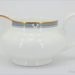 Marks & Spencer - Felsham - Gravy Boat - White ceramic pitcher with decorative blue band and gold handle on a white background